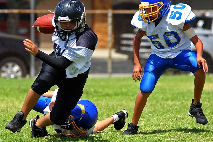Three young people are wearing full gear including helmets, 