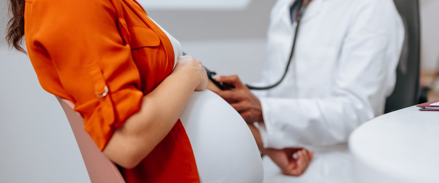 Woman in orange shirt is in doctor's office