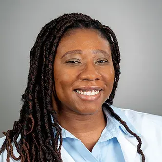 LaToya Augustine has long dark hair styled in long braids, i