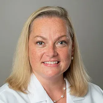 FNP Corbine has long blonde hair, is wearing a white medical