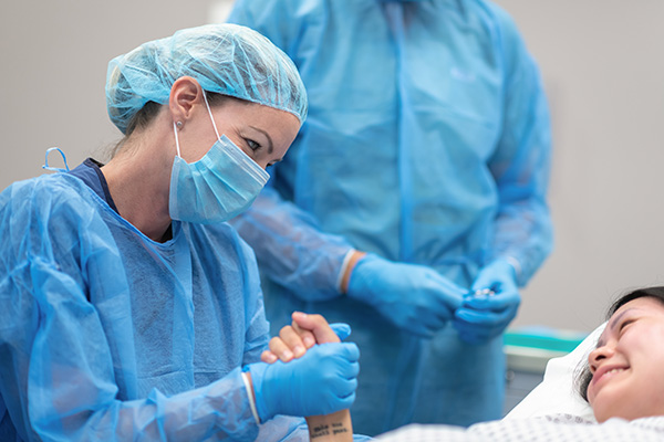Surgeon comforts a patient in operating room